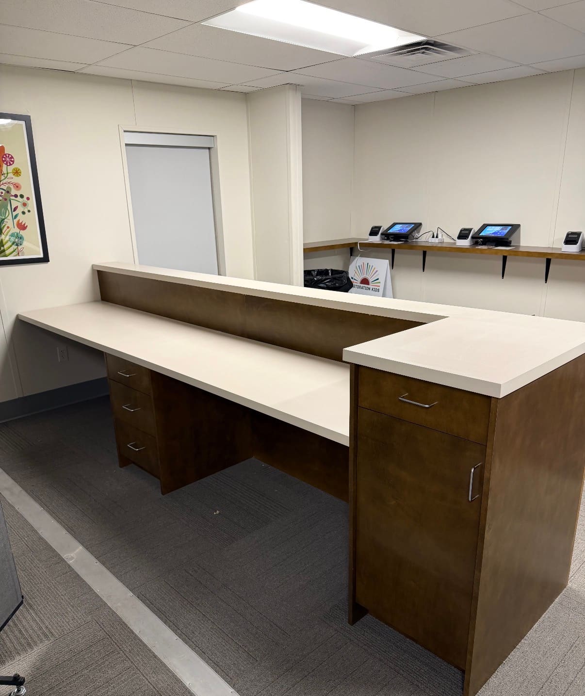 Restoration Church — warm wood reception desk with solid surface top, Bryan, TX