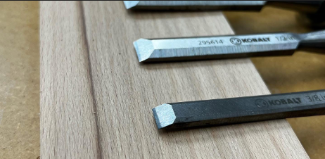 Wood chisels resting on a hardwood board in the Silver Branch Millwork shop